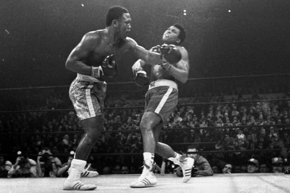 Joe Frazier hits Muhammad Ali with a left during the 15th round of their heavyweight title figh ...