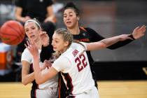 Stanford Cardinal guard Lexie Hull (12), left, and forward Cameron Brink (22) fall back after a ...