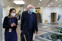 Sen. Bernie Sanders, I-Vt., chair of the Senate Budget Committee, returns to his office while t ...