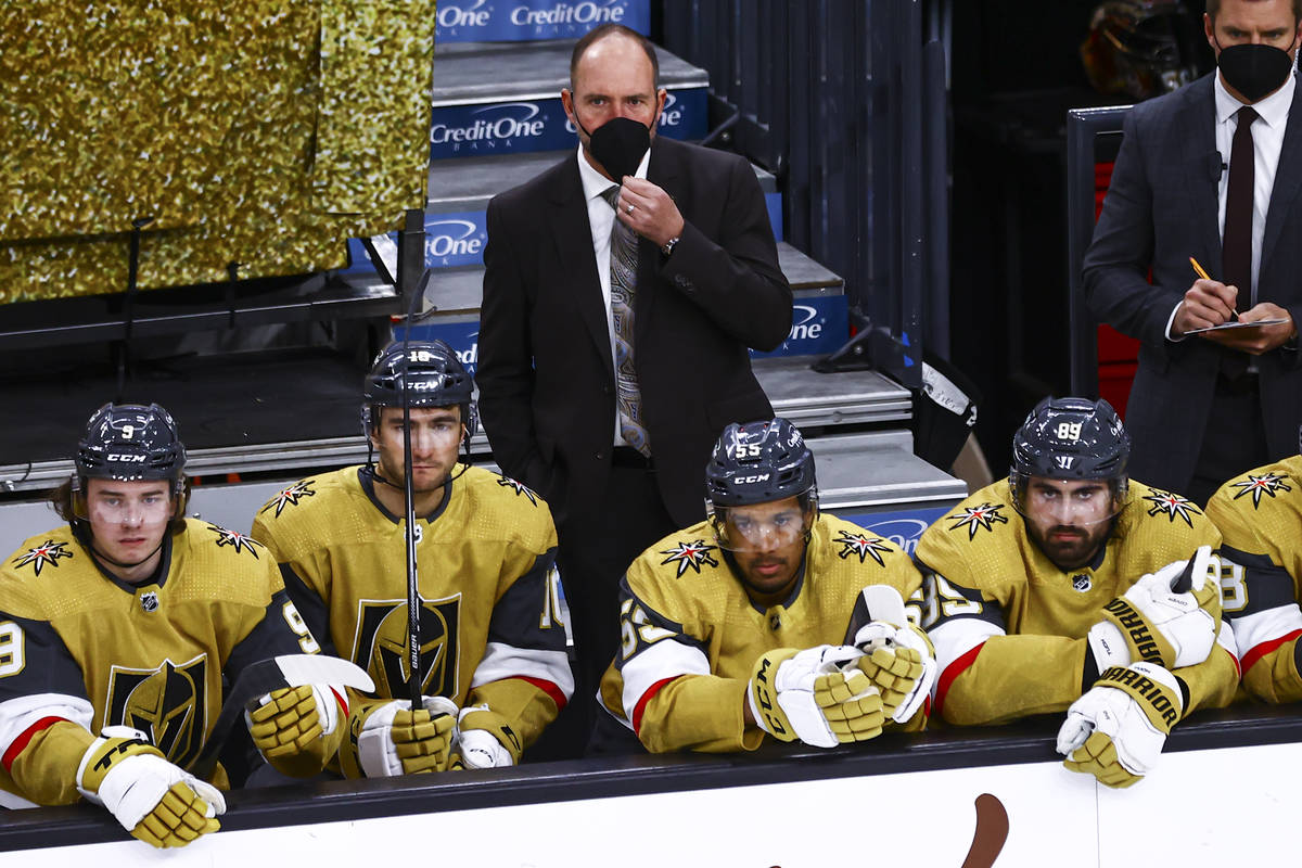 Golden Knights head coach Pete DeBoer looks on from the bench during the third period of an NHL ...