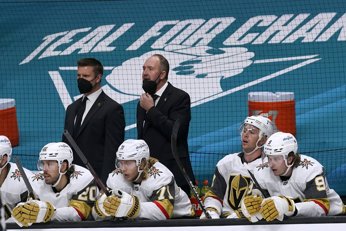 Vegas Golden Knights coach Peter DeBoer, top right, watches from the bench during the second pe ...
