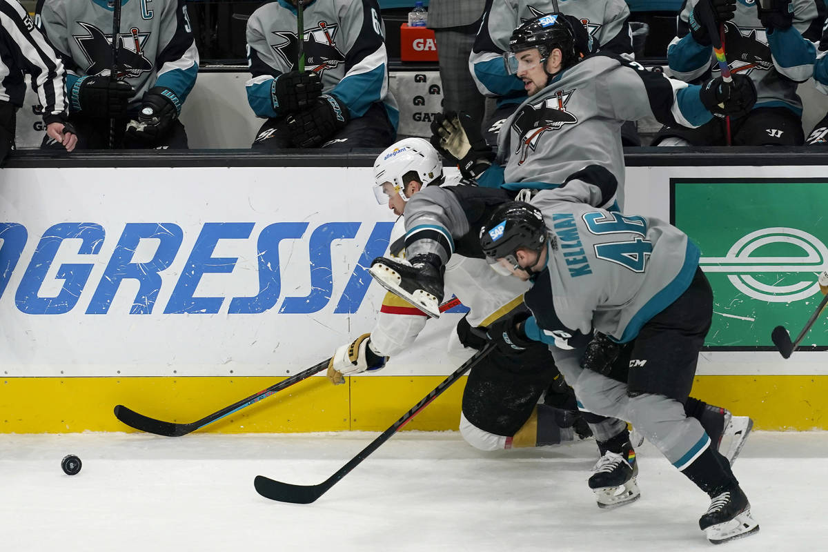 Vegas Golden Knights left wing William Carrier, left, reaches for the puck in front of San Jose ...