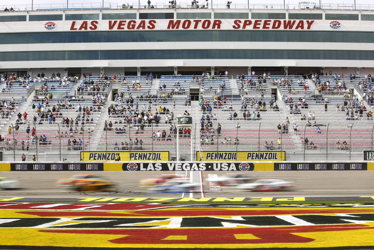 Drivers pass the start/finish line during a restart in a NASCAR Xfinity Series auto race at the ...