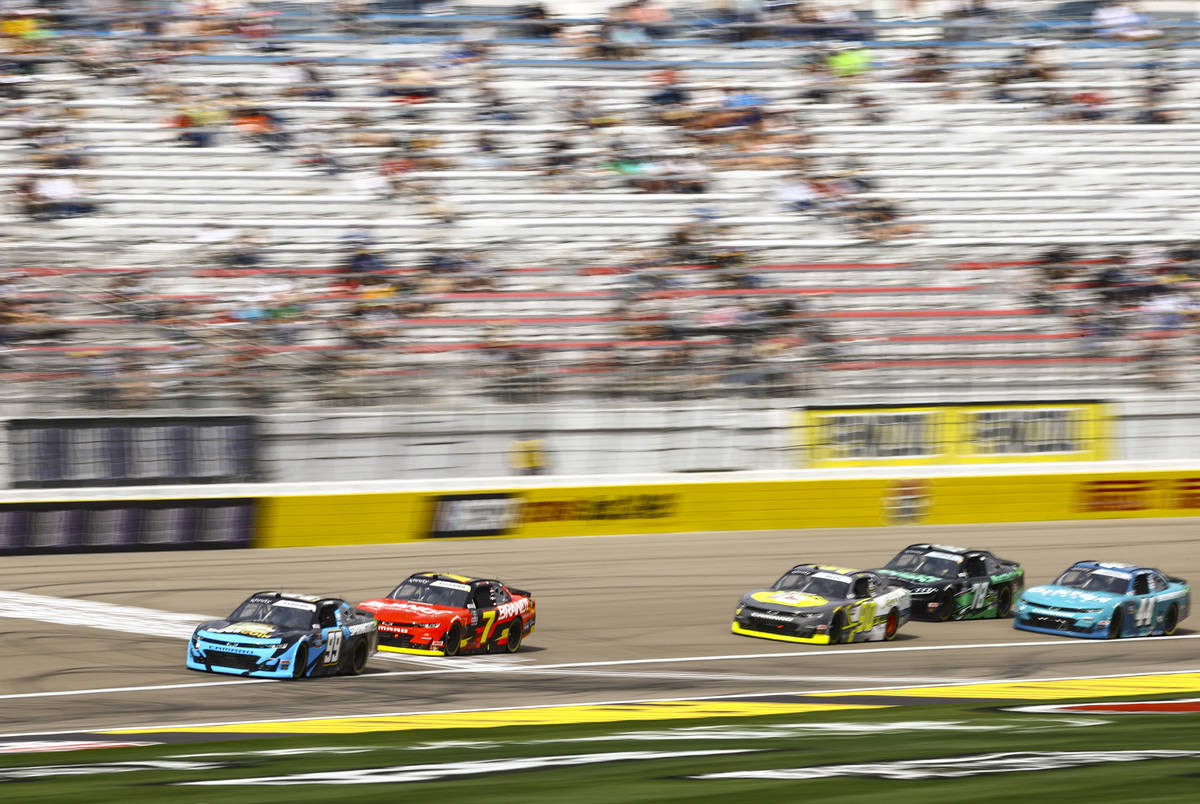 Drivers pass the start/finish line during a NASCAR Xfinity Series auto race at the Las Vegas Mo ...