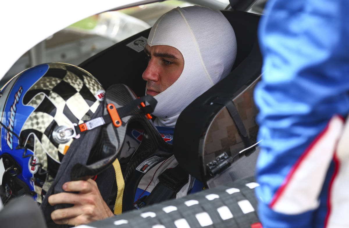 Austin Cindric gets ready to put on his helmet before a NASCAR Xfinity Series auto race at the ...
