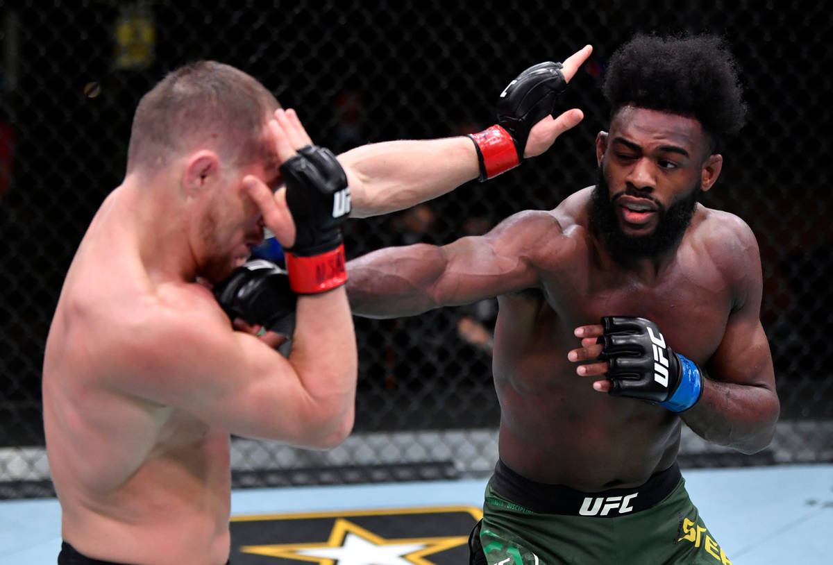 LAS VEGAS, NEVADA - MARCH 06: (R-L) Aljamain Sterling punches Petr Yan of Russia in their UFC b ...
