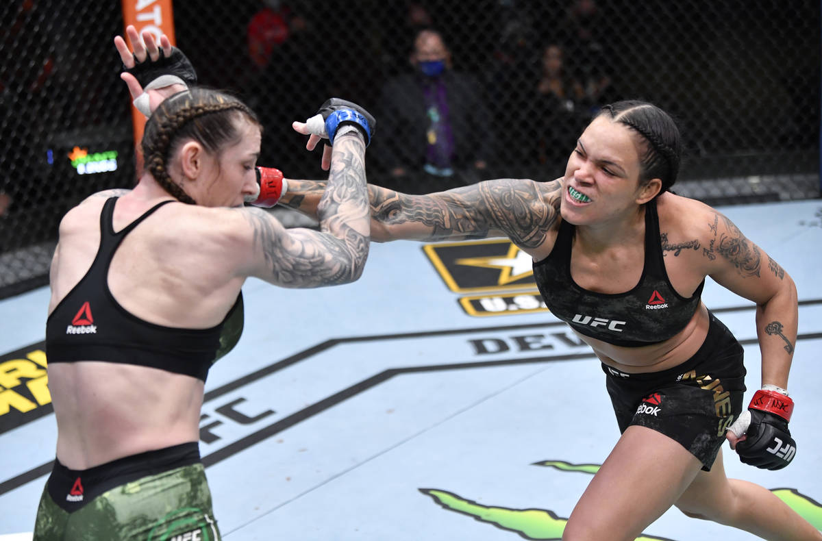 LAS VEGAS, NEVADA - MARCH 06: (R-L) Amanda Nunes of Brazil punches Megan Anderson of Australia ...