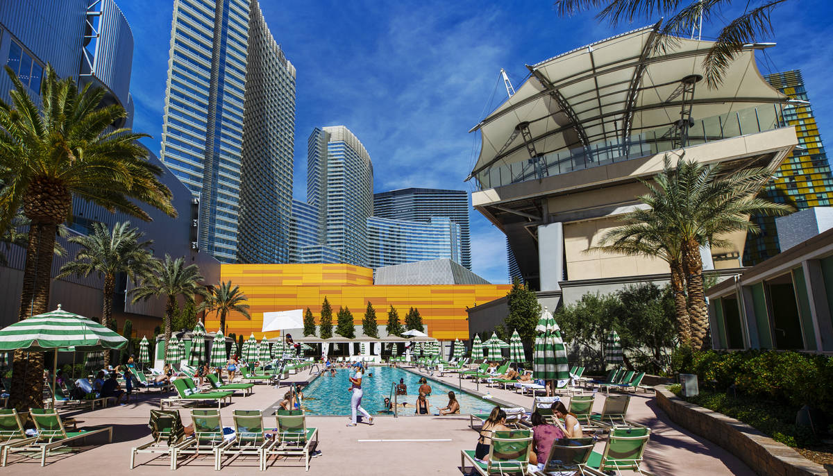 Guests lounge by the pool at Aria on Saturday, March 6, 2021, in Las Vegas. (Benjamin Hager/Las ...