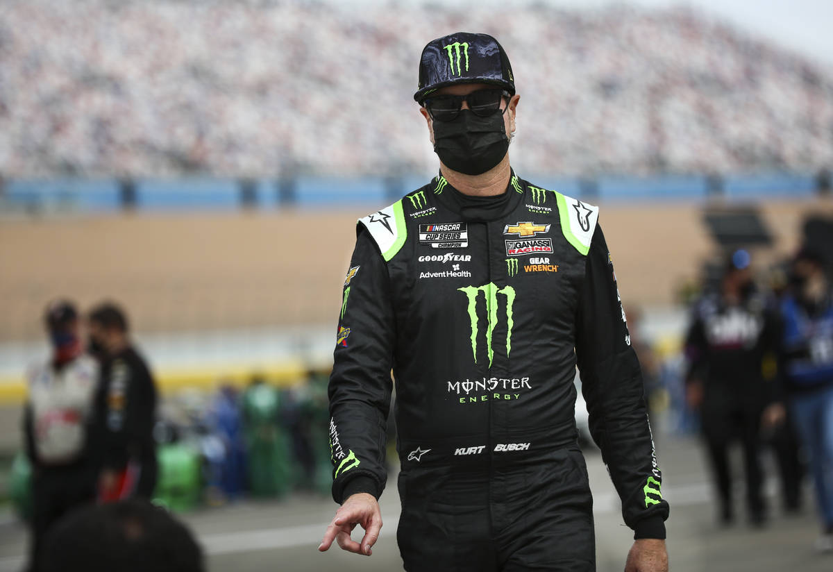 Kurt Busch walks to his car before the start of the NASCAR Cup Series Pennzoil 400 auto race at ...