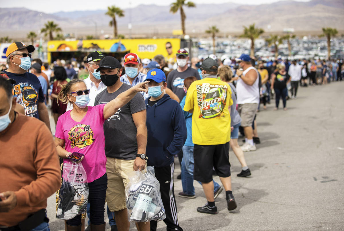 NASCAR fans wait in line to get their tickets scanned before the start of the NASCAR Cup Series ...