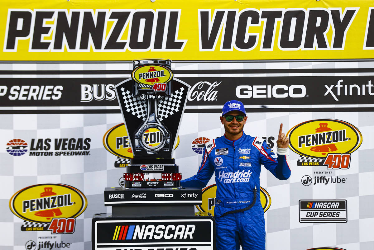 Kyle Larson poses with the trophy after winning the NASCAR Cup Series Pennzoil 400 auto race at ...