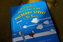 A copy of the book "And to Think That I Saw It on Mulberry Street," by Dr. Seuss, rests in a ch ...
