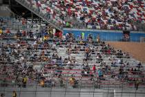 Fans watch the action during the NASCAR Cup Series Pennzoil 400 auto race at the Las Vegas Moto ...