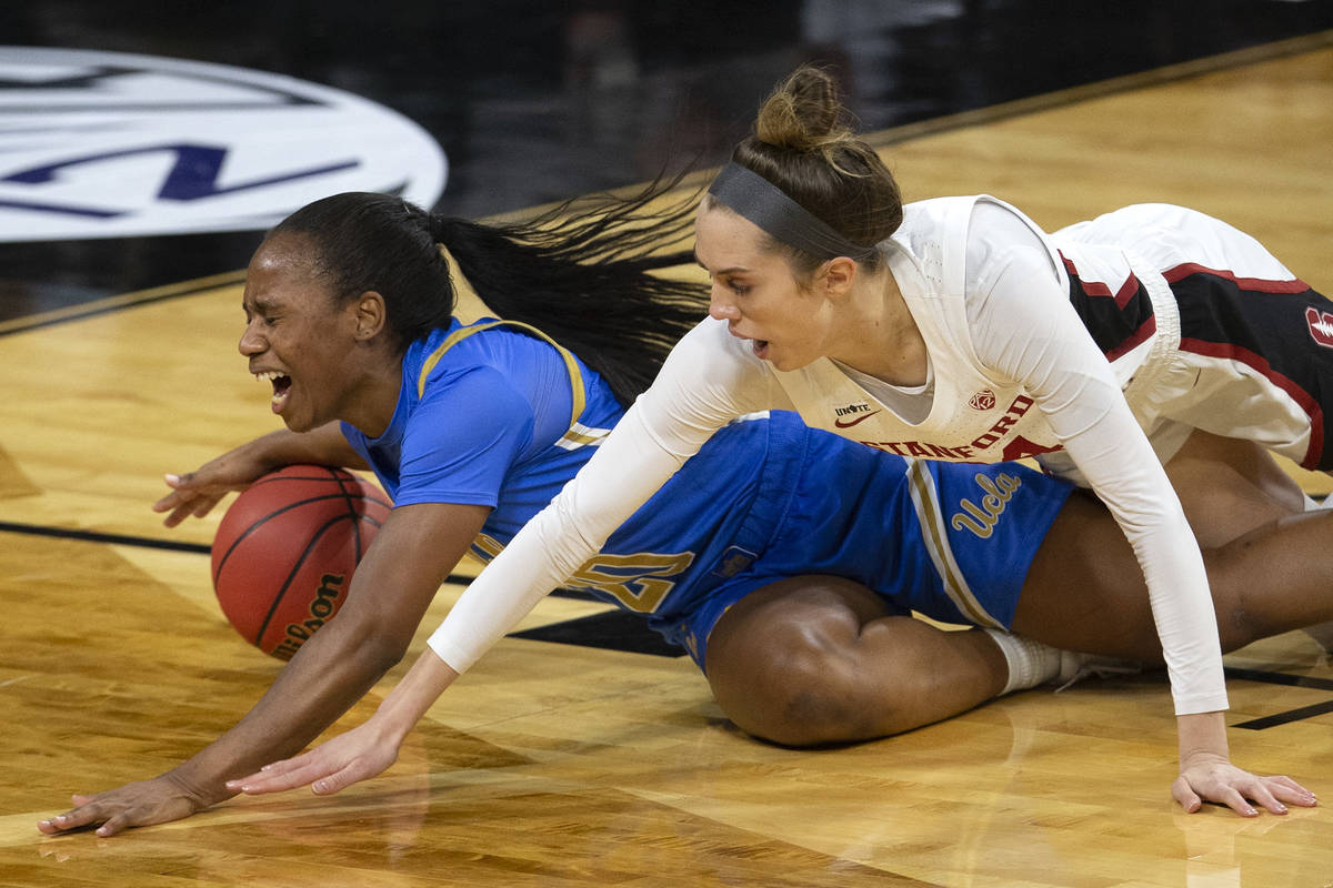 UCLA Bruins guard Natalie Chou (23) and Stanford Cardinal guard Lacie Hull (24) dive for the ba ...