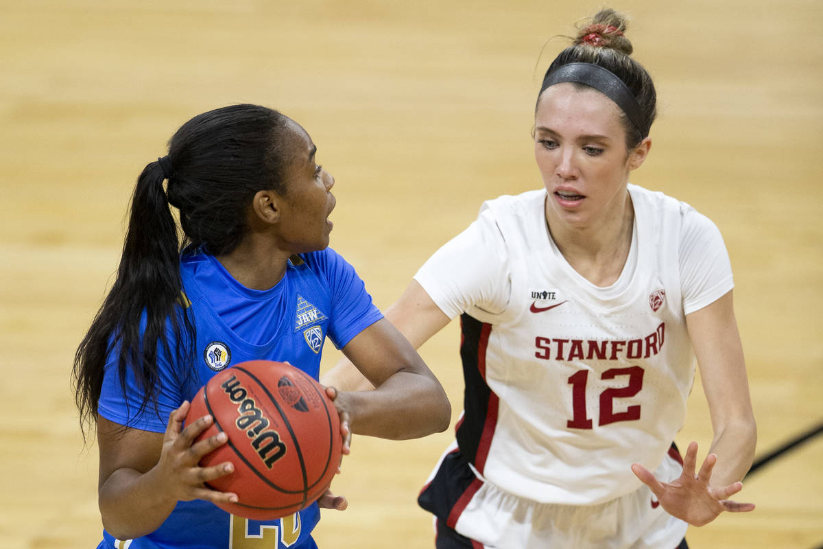 UCLA Bruins guard Charisma Osborne (20) looks to pass while Stanford Cardinal guard Lexie Hull ...