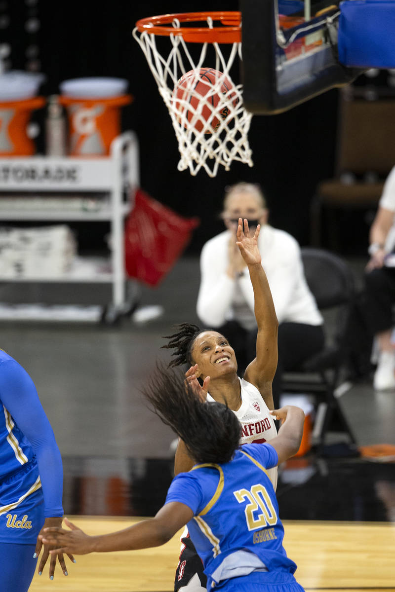 Stanford Cardinal guard Kiana Williams (23) shoots a point while UCLA Bruins guard Charisma Osb ...