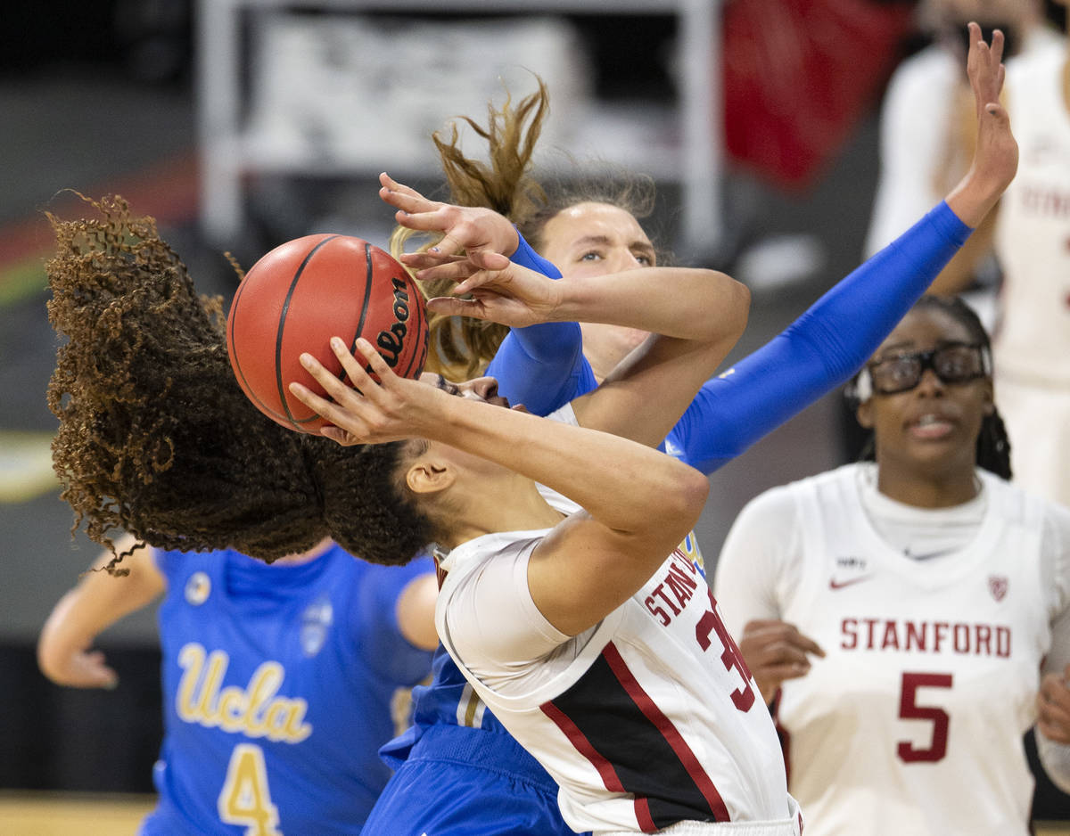 Stanford Cardinal guard Anna Wilson (3) attempts a point while UCLA Bruins forward Emily Bessoi ...
