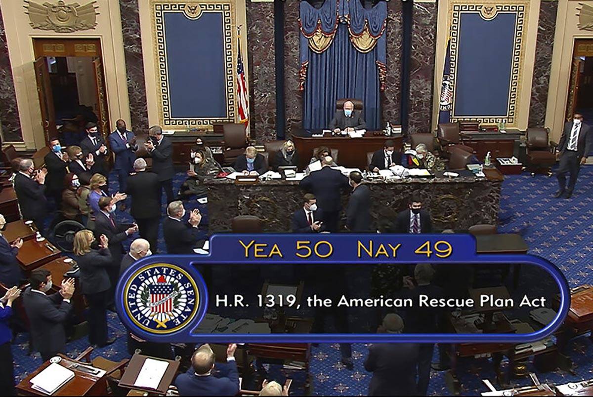In this image from video, the vote total of 50-49 on Senate passage of the COVID-19 relief bill ...