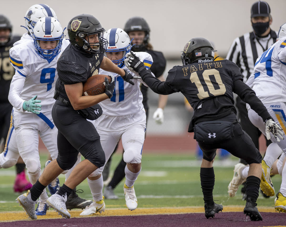 Faith LutheranÕs Marcos Canales (9) heads for the end zone with a block from QB Jaden Turn ...