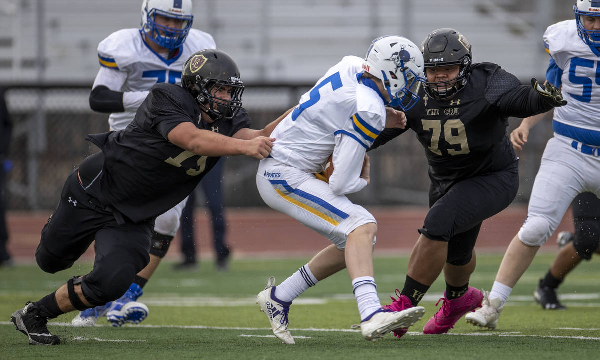 Moapa ValleyÕs QB Cameron Reese (5) is sacked by Faith LutheranÕs defensemen during t ...