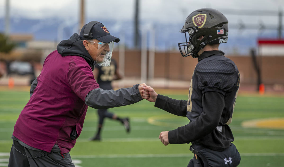 Faith LutheranÕs head coach Mike Sanford Sr. congratulates QB Jaden Turner (10) on a score ...