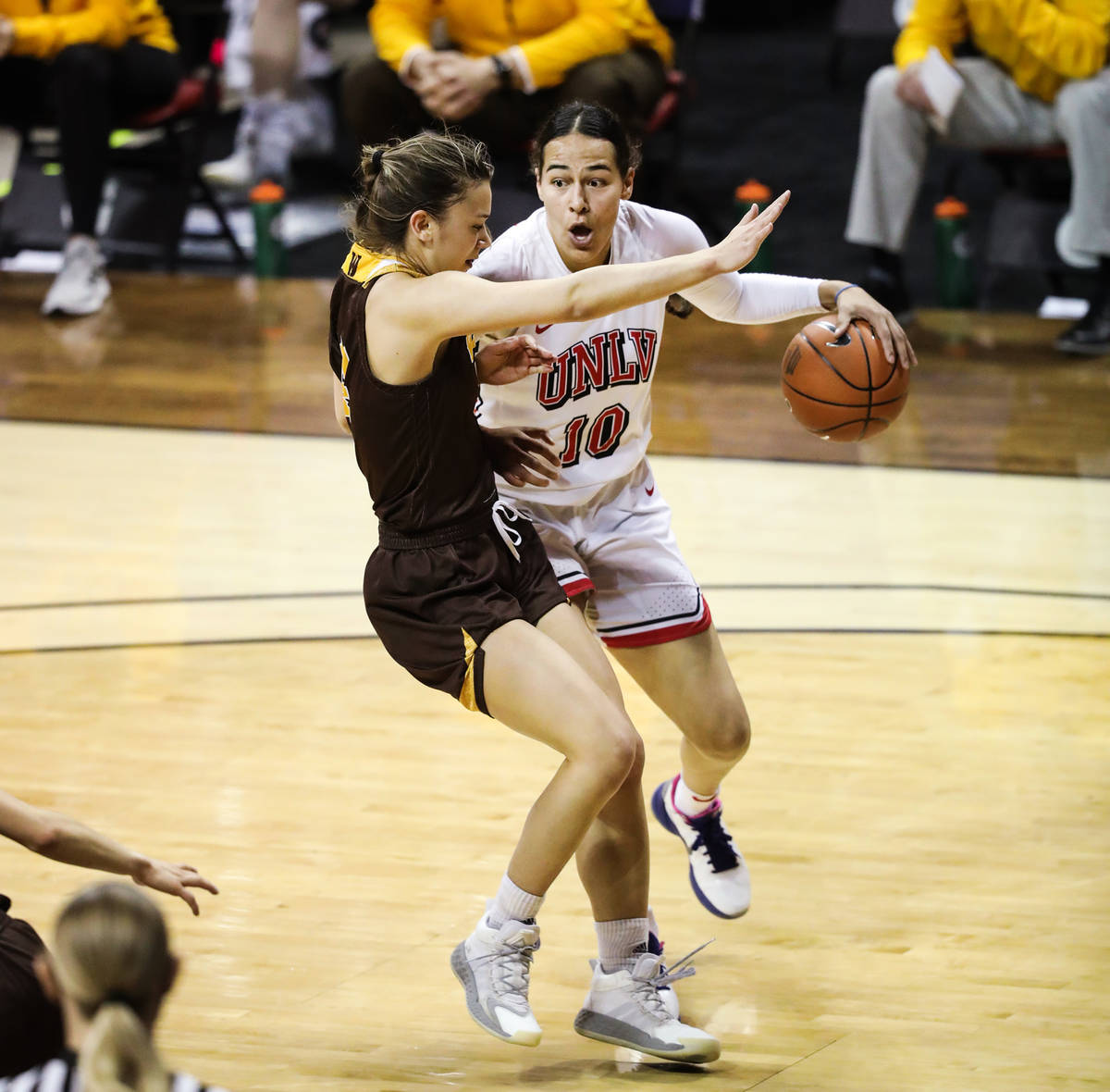 UNLV guard Jacinta Buckley (10) tries to push past Wyoming guard Quinn Weidemann (14) in the fi ...