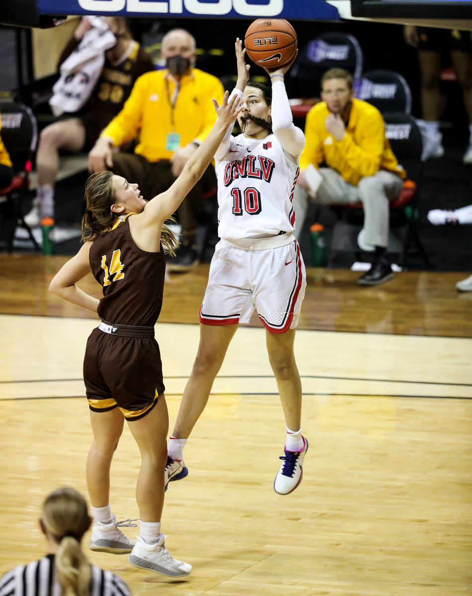 UNLV guard Jacinta Buckley (10) attempts a basket against Wyoming guard Quinn Weidemann (14) in ...