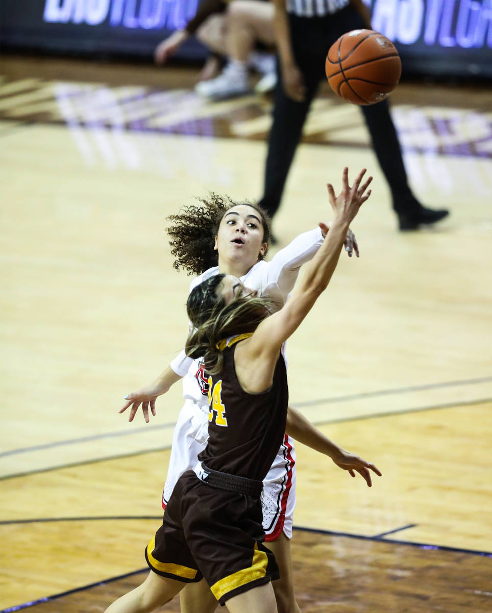 UNLV center Keyana Wilfred (15) passes the ball past Wyoming guard Tommi Olson (24) in the seco ...
