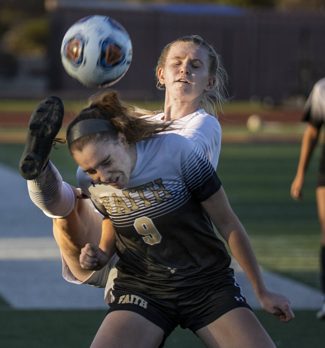 Faith Lutheranճ Claire Dalbec (9) has a ball kicked past her head by Bishop Gormanճ ...