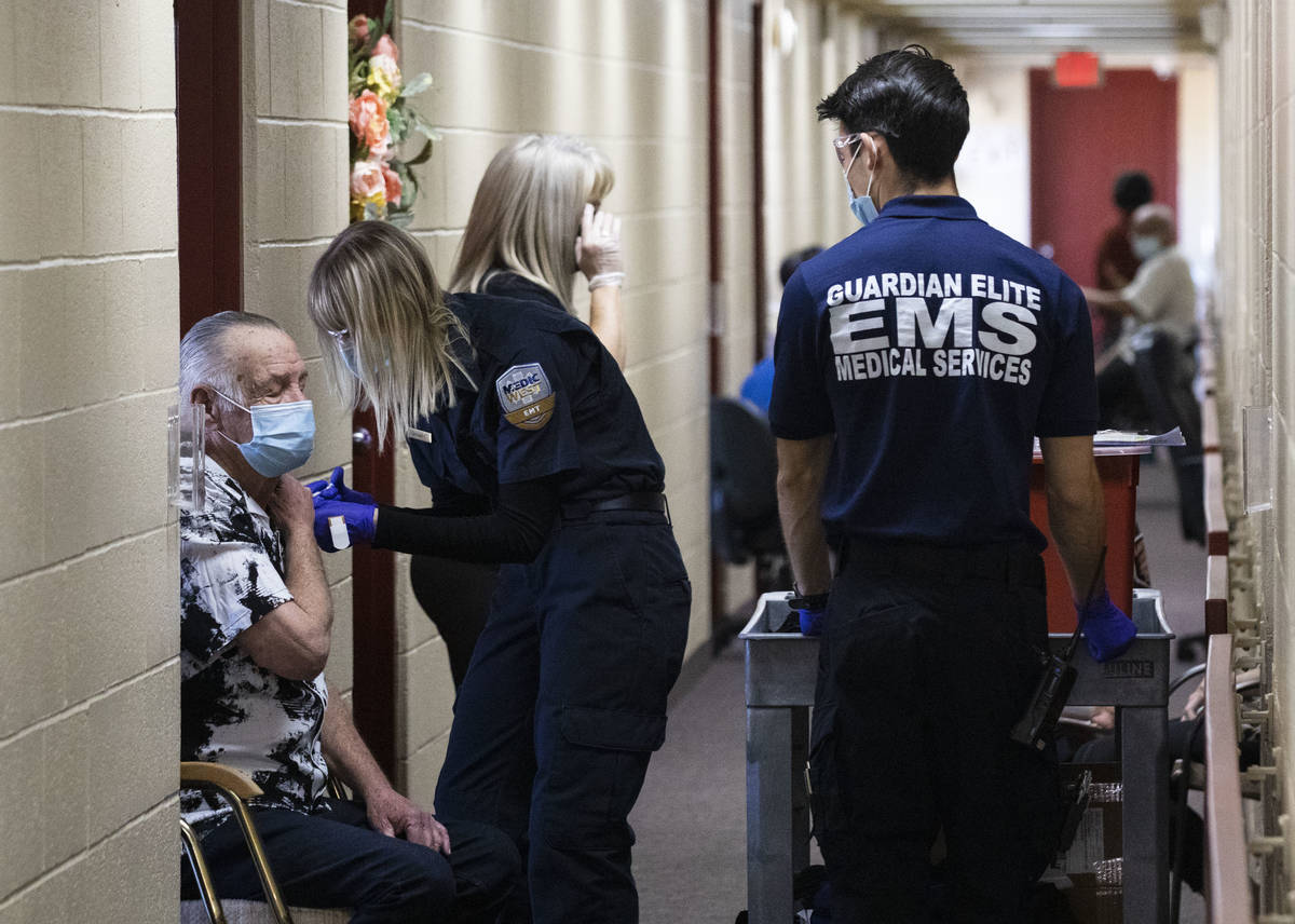 Brittany Fisher of MedicWest Ambulance administers a COVID-19 vaccine to the Stella Fleming Tow ...