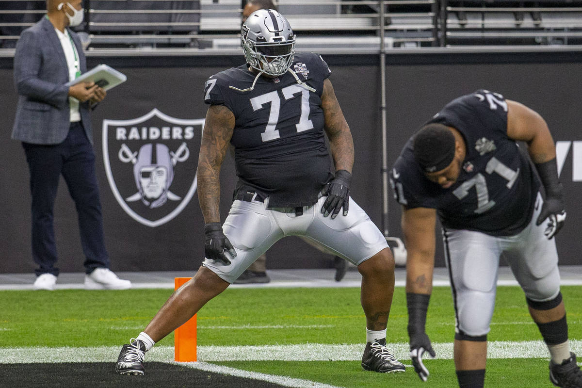 Raiders offensive tackle Trent Brown (77) stretches before an NFL football game against the Ind ...
