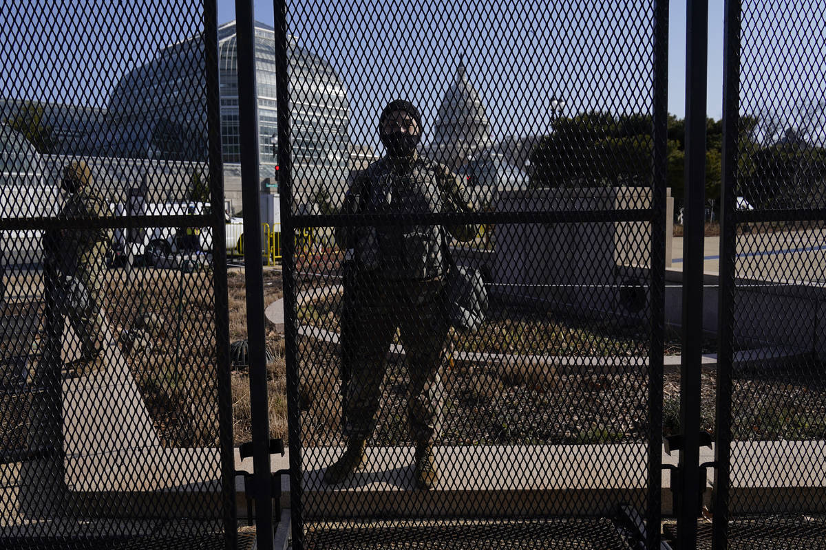 National Guard stand guard at a perimeter fence at the Capitol in Washington, Thursday, March 4 ...