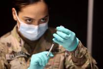Nevada National Guard Spc. Jessica Lawrence prepares Pfizer vaccines at the Cashman Center COVI ...