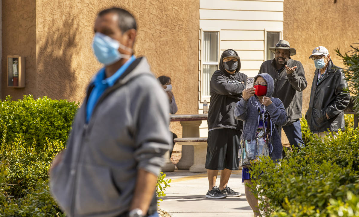 Residents look on as the Clark County and Las Vegas Fire Departments work a fire at Twain Estat ...