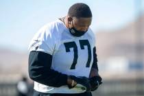 Las Vegas Raiders offensive tackle Trent Brown (77) warms up with a mask on during a practice ...