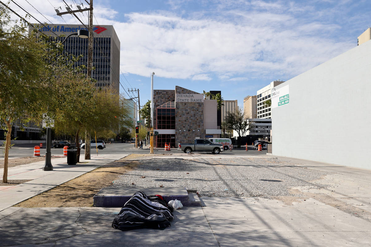 A person sleeps on Carson Avenue near Las Vegas Boulevard in downtown Las Vegas Tuesday, March ...