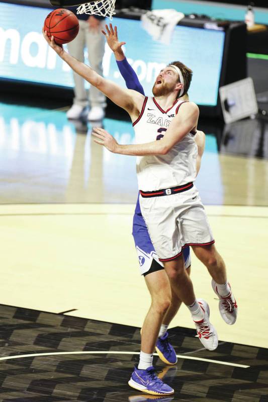 Gonzaga Bulldogs forward Drew Timme (2) goes up for a shot under pressure from Brigham Young Co ...