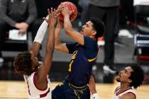 California's Jarred Hyder (3) shoots over Stanford's Daejon Davis left, and Bryce Wills during ...