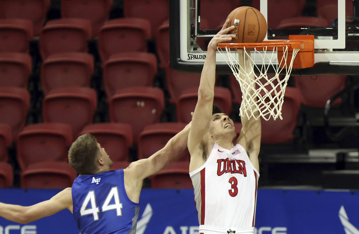 UNLV guard Caleb Grill (3) dunks as Air Force forward Keaton Van Soelen (44) defends during the ...