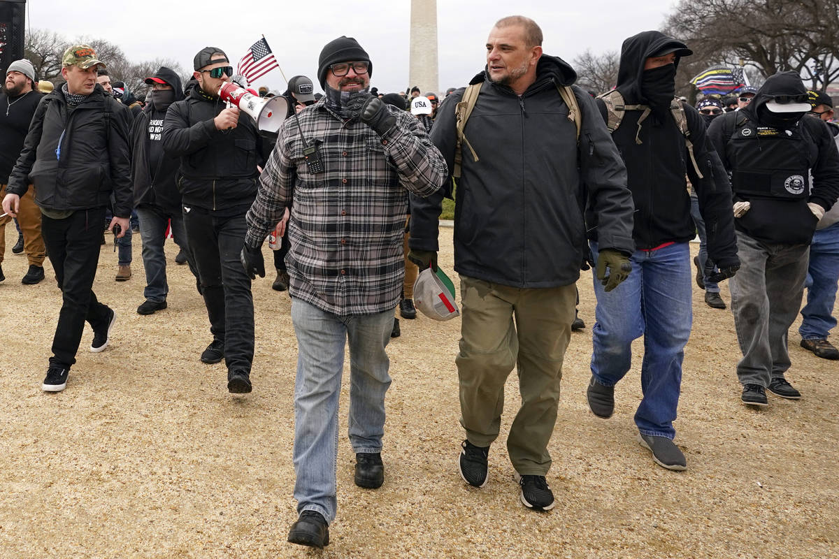 In this Jan. 6, 2021, photo, Proud Boys including Joseph Biggs, front left, walks toward the U. ...