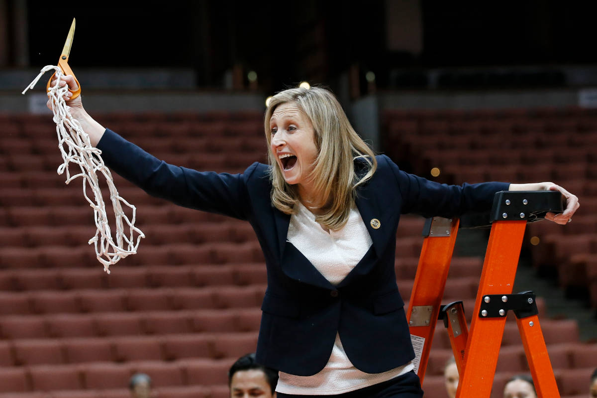 UC Davis coach Jennifer Gross celebrates after her team defeated Hawaii during an NCAA college ...