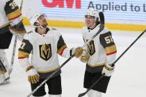 Vegas Golden Knights' Dylan Coghlan (52) smiles with his teammate Shea Theodore (27) after Cogh ...