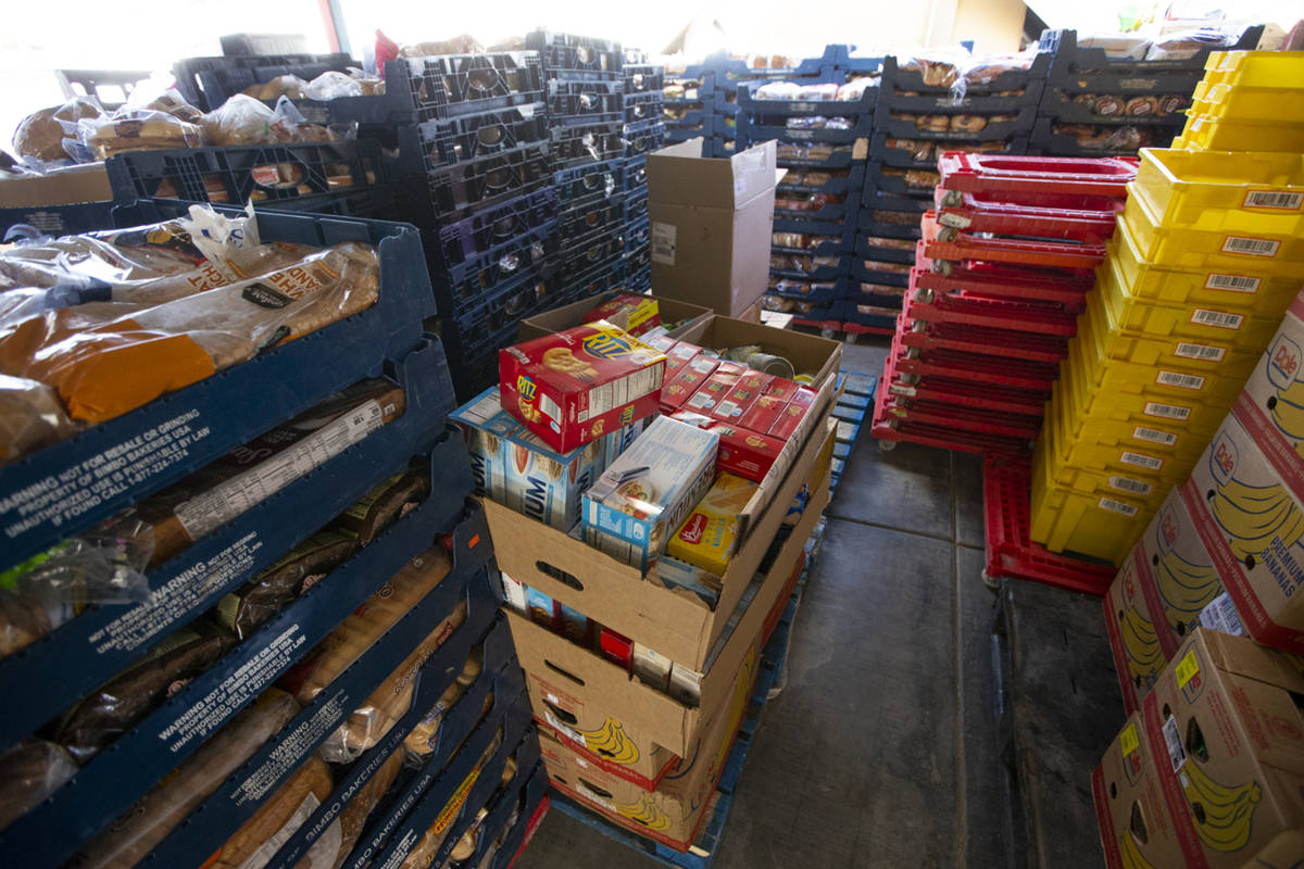 Crates filled with donated food sit waiting to be organized at the City Impact Urban Food Bank ...