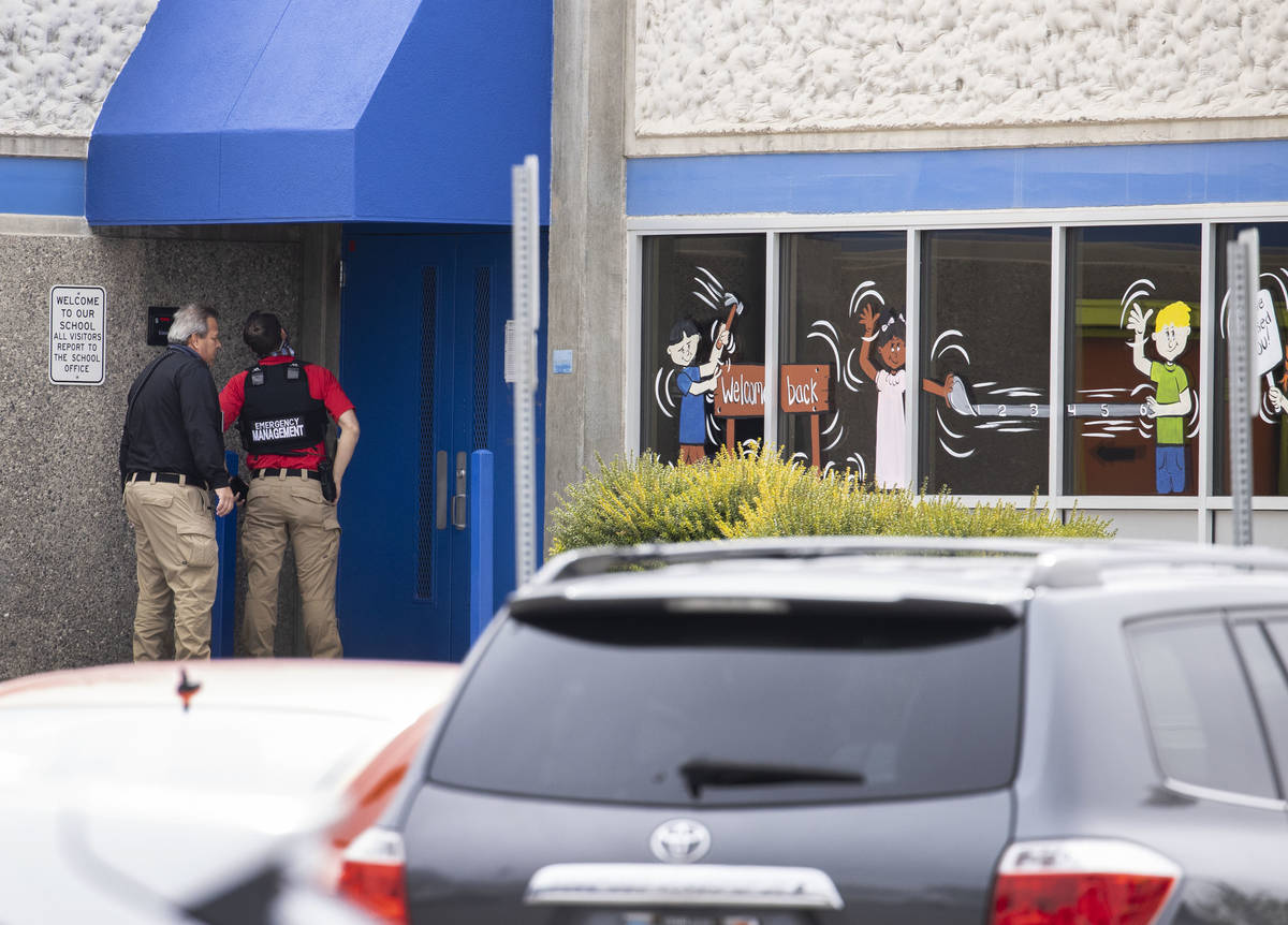 Law enforcement officers investigate a shooting outside of George Harris Elementary School in L ...