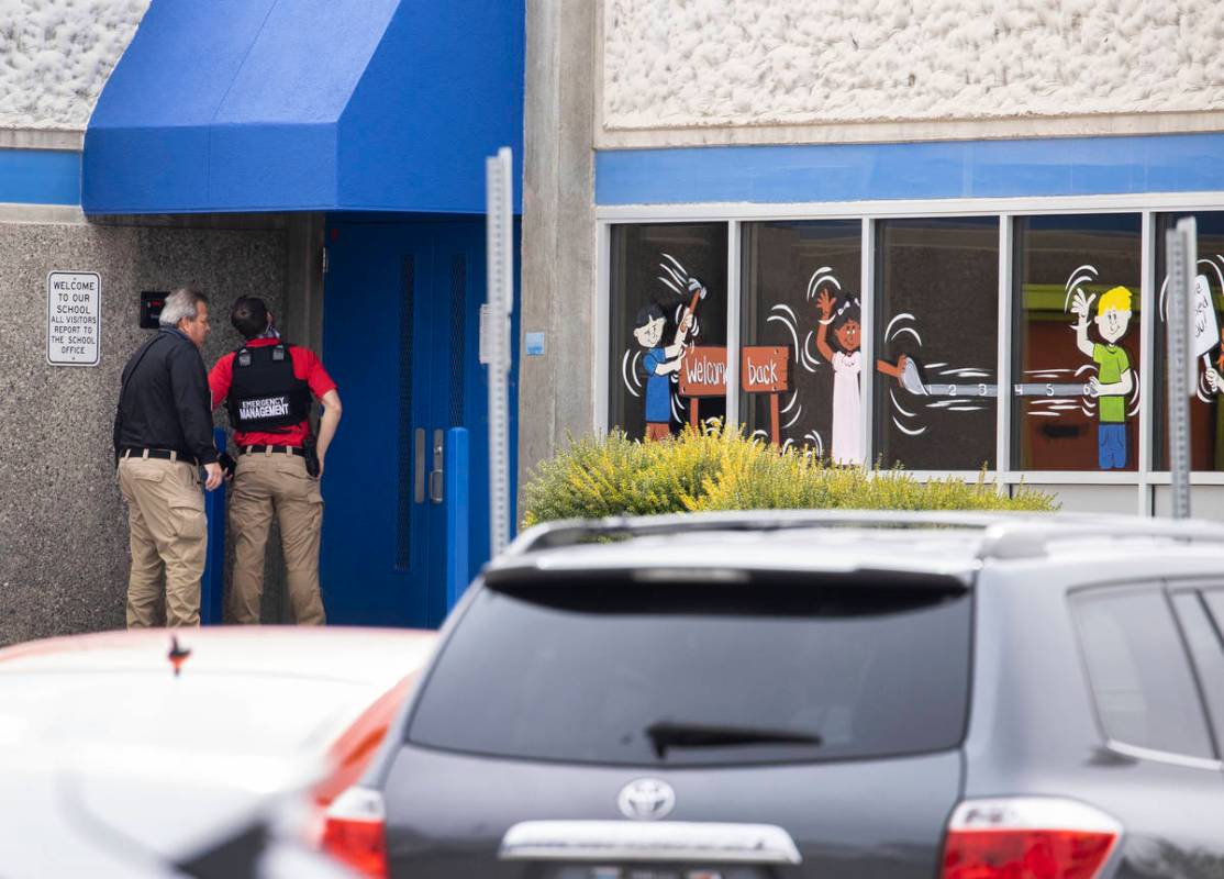 Law enforcement officers investigate a shooting outside of George Harris Elementary School in L ...
