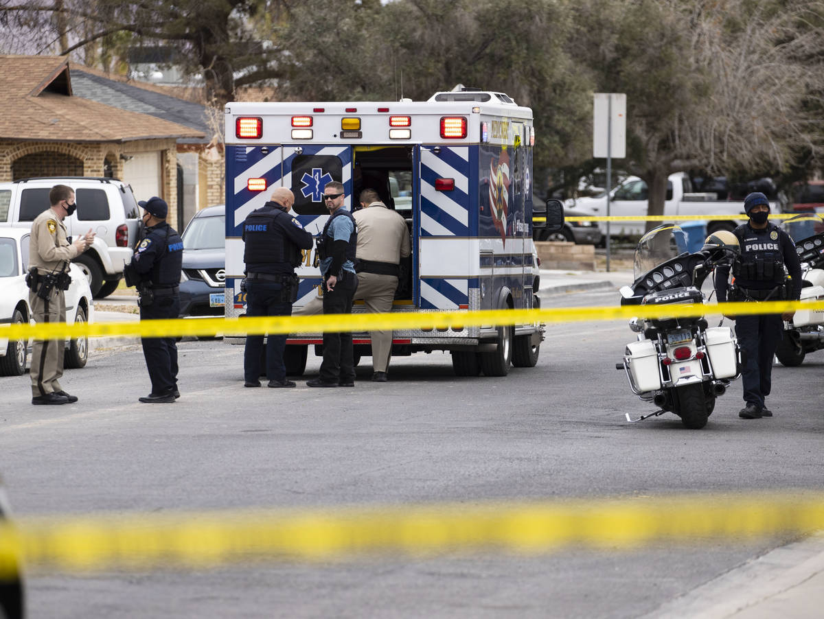 Law enforcement officers investigate a shooting near George Harris Elementary School in Las Veg ...