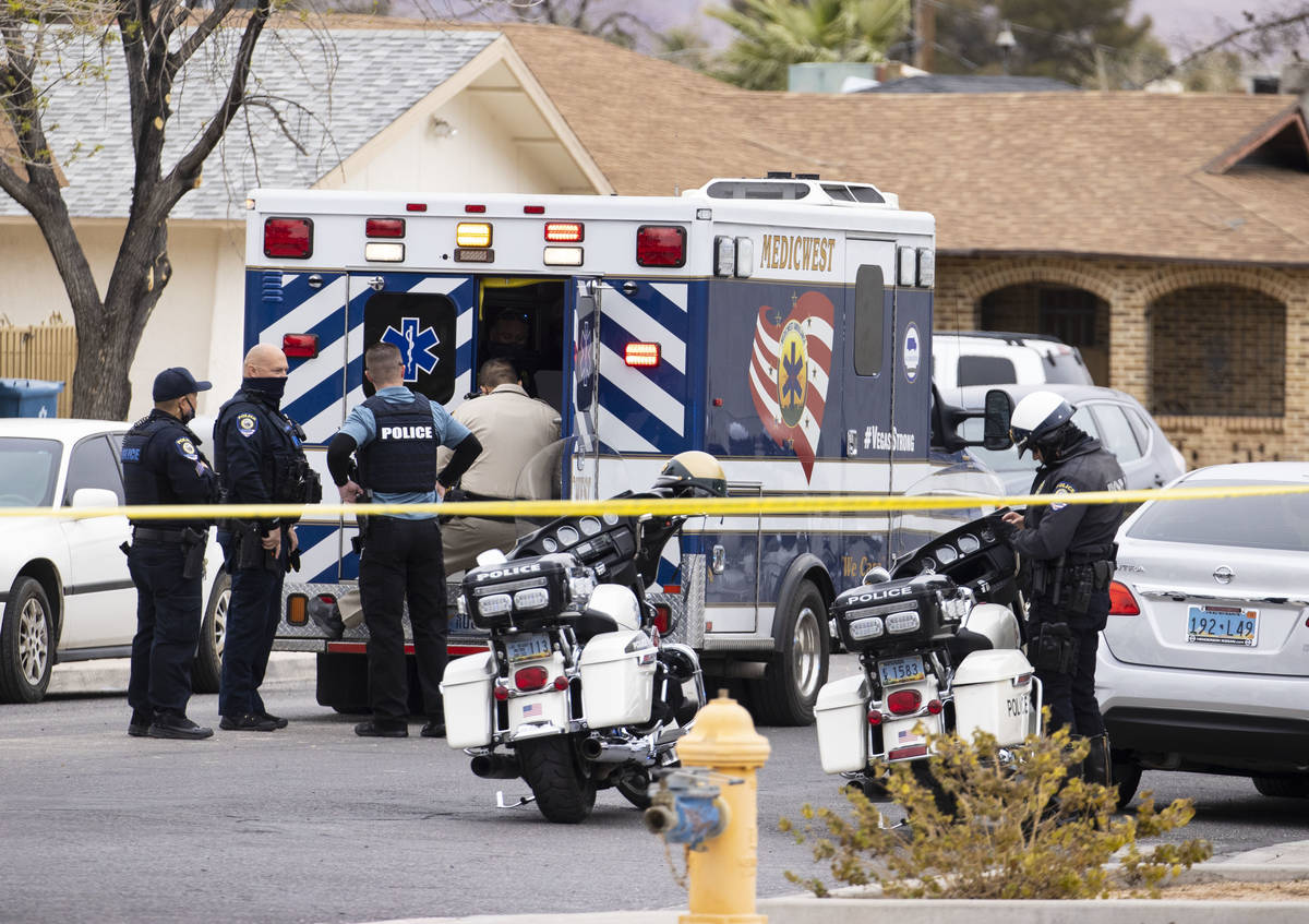 Law enforcement officers investigate a shooting near George Harris Elementary School in Las Veg ...