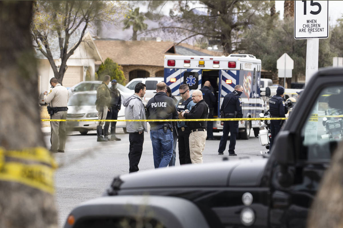Law enforcement officers investigate a shooting near George Harris Elementary School in Las Veg ...