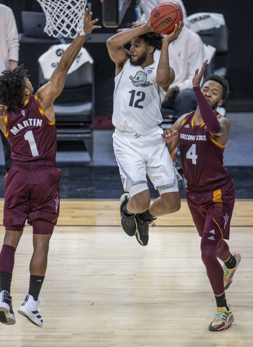 Oregon Ducks guard LJ Figueroa (12) catches some air to beat Arizona State Sun Devils guard Rem ...