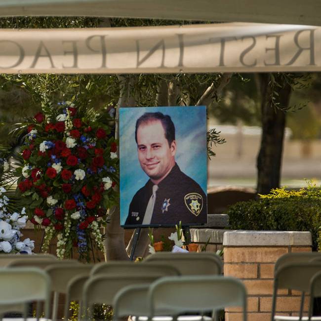 A portrait awaits mourners before a burial service for Las Vegas police Lt. Erik Lloyd on Aug. ...